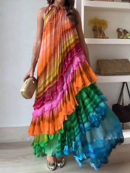 Woman wearing a colorful tiered dress in a room with shelves in the background